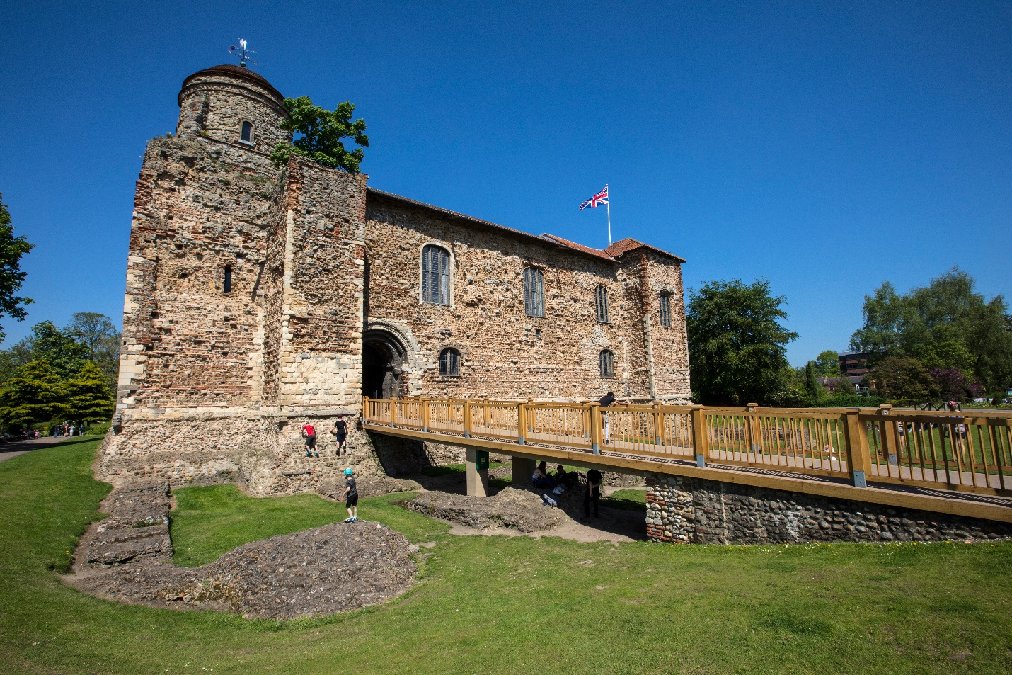 Colchester Castle in Essex with visitors and clear blue sky